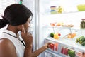 Young Woman Looking In Fridge