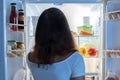 Young Woman Looking In Fridge Royalty Free Stock Photo