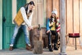 Young woman looking at handsome man chopping firewood with axe on porch Royalty Free Stock Photo