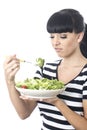 Young Woman Looking at Healthy Bowl of Green Salad Leaves with distaste Royalty Free Stock Photo