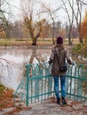 A young woman looking at a lake in a park