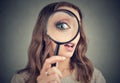 Young woman looking through magnifier