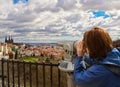 Young woman looking at Mala Strana and St. Vitus Cathedral in Pr
