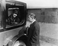 Young woman looking at a man through a car window Royalty Free Stock Photo