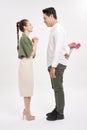 Young woman looking at man with flower bouquet behind the back Royalty Free Stock Photo