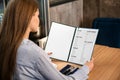 Young woman looking through menu in restaurant Royalty Free Stock Photo