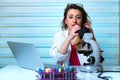 Young woman looking through a microscope in the lab Royalty Free Stock Photo