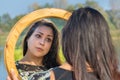 Woman looking at mirror in nature Royalty Free Stock Photo