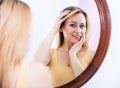 Young woman looking in the mirror Royalty Free Stock Photo