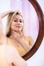 Young woman looking in the mirror Royalty Free Stock Photo