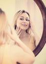 Young woman looking in the mirror Royalty Free Stock Photo