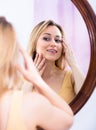 Young woman looking in the mirror Royalty Free Stock Photo