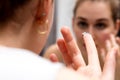 Young woman looking in mirror to change her contact lens Royalty Free Stock Photo