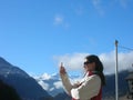 Young woman looking at mobile phone, in outdoor/nature setting