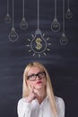 Young Woman looking Money bulb Royalty Free Stock Photo