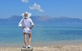 Young woman looking at the mountains above sea Royalty Free Stock Photo