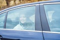 Young woman looking out car window reflections on glass Royalty Free Stock Photo