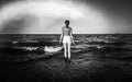 Young Dressed Woman Looking Out To Sea in Black and White Royalty Free Stock Photo