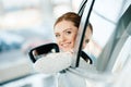 Young woman looking out window of new car Royalty Free Stock Photo