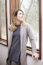 Young woman looking out window in winter Royalty Free Stock Photo