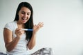 Young woman looking at pregnance test in happiness