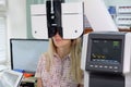 Young woman looking at refractometer eye test machine in ophthalmology Royalty Free Stock Photo