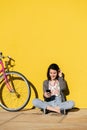 Young woman looking smart phone next to her bike Royalty Free Stock Photo