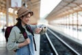 Young woman looking at smart watch with backpack. Young woman waiting for train