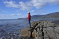 Young woman hiking over the Tessellated Pavement in Tasman Peninsula Tasmania Australia Royalty Free Stock Photo