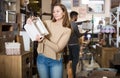 Woman looking for stylish knickknacks for apartment in shop Royalty Free Stock Photo