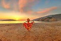 Young woman looking the sunrise from Livadi beach in Folegandros, Greece Royalty Free Stock Photo