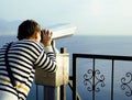 Young woman looking through telescope at sea viewpoint in Ataturk park Royalty Free Stock Photo
