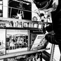 Young Woman Looking Though Collection Of Vinyl Long Playing Records