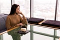 Young woman looking thoughtfully out the window on a winter day Royalty Free Stock Photo