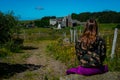 Young woman looking towards Aubrac village ,a stage on the compostelle walk or saint James way, with wild flowers in foreground