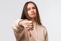 Young woman looking unhappy and angry showing dislike with thumb down, rejection concept Royalty Free Stock Photo