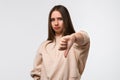 Young woman looking unhappy and angry showing dislike with thumb down, rejection concept Royalty Free Stock Photo