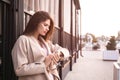 Young woman looking at watch while waiting for her boyfriend outdoors Royalty Free Stock Photo