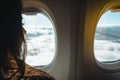 Young woman looking into window in a plane. Woman in a plane. Woman looking into porthole. Traveling by plane concept. Royalty Free Stock Photo