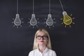 Young Woman looking light bulbs Royalty Free Stock Photo