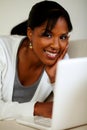 Young woman looking at you in front of her laptop Royalty Free Stock Photo