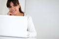 Young woman looking at you in front of her laptop Royalty Free Stock Photo