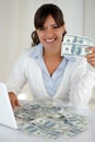 Young woman looking at you holding cash money Royalty Free Stock Photo