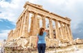 Young woman looks at Ancient Greek Parthenon on the Acropolis of Athens, Greece Royalty Free Stock Photo