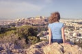 Young woman looks at cityscape of Athens from above, Greece