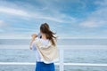 A young woman looks through coin binoculars, rear view. Royalty Free Stock Photo