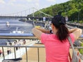 Young woman looks at the embankment, bridge and river Royalty Free Stock Photo