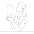 Young woman looks in a hand mirror