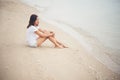 Young woman with looks lonely feel sit on the beach. Sad woman a