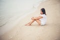 Young woman with looks lonely feel sit on the beach. Sad woman a